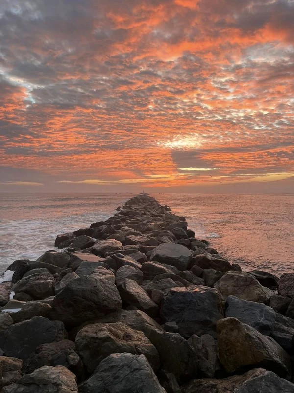 Sun rise over an ocean jetty